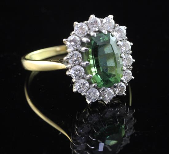 An 18ct gold, green tourmaline and diamond cluster ring, size O.